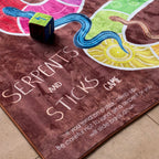 Serpents and Sticks Rug Game with soft Dice — close-up of design