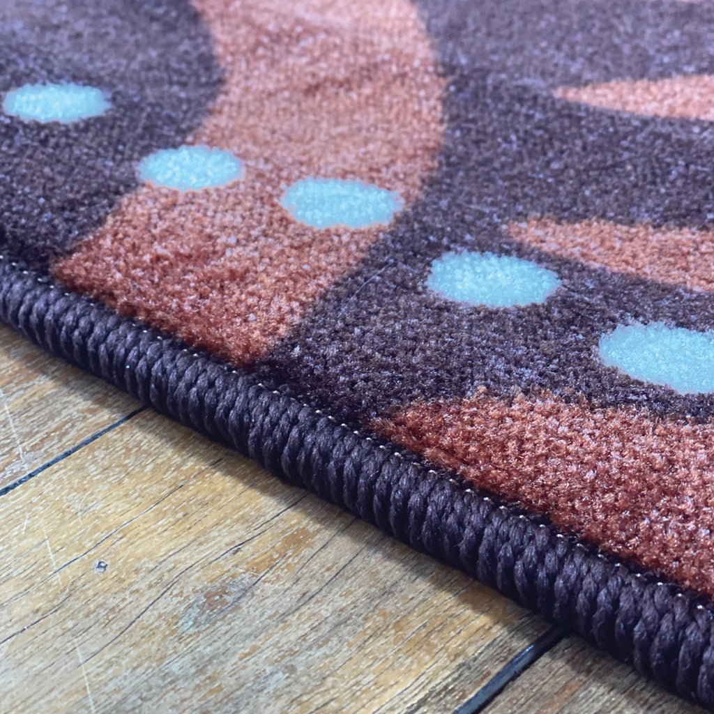 Alphabet Earth Serpent Indigenous Rug — in classroom use