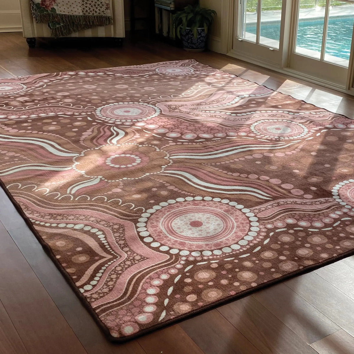 Aboriginal Art Bush Dreaming rug in classroom — children sitting on Indigenous art rug during group reading time