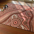 Aboriginal Art Desert Dreaming rug in classroom — children sitting on Indigenous art rug during group learning time